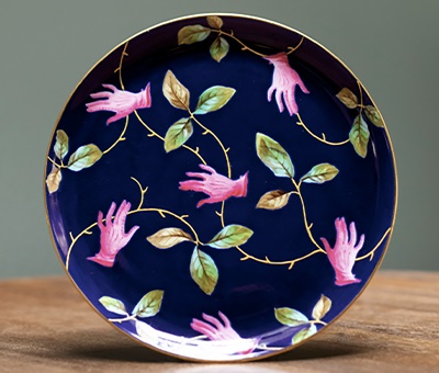 § SALVADOR DALI (SPANISH 1904-1989) FOR ROYAL CROWN DERBY 'PINK GLOVE' PLATE, CIRCA 1938 manufacturer's printed and impressed marks, Christies paper label 23cm diameter (9in diameter) | Sold for £4,750*